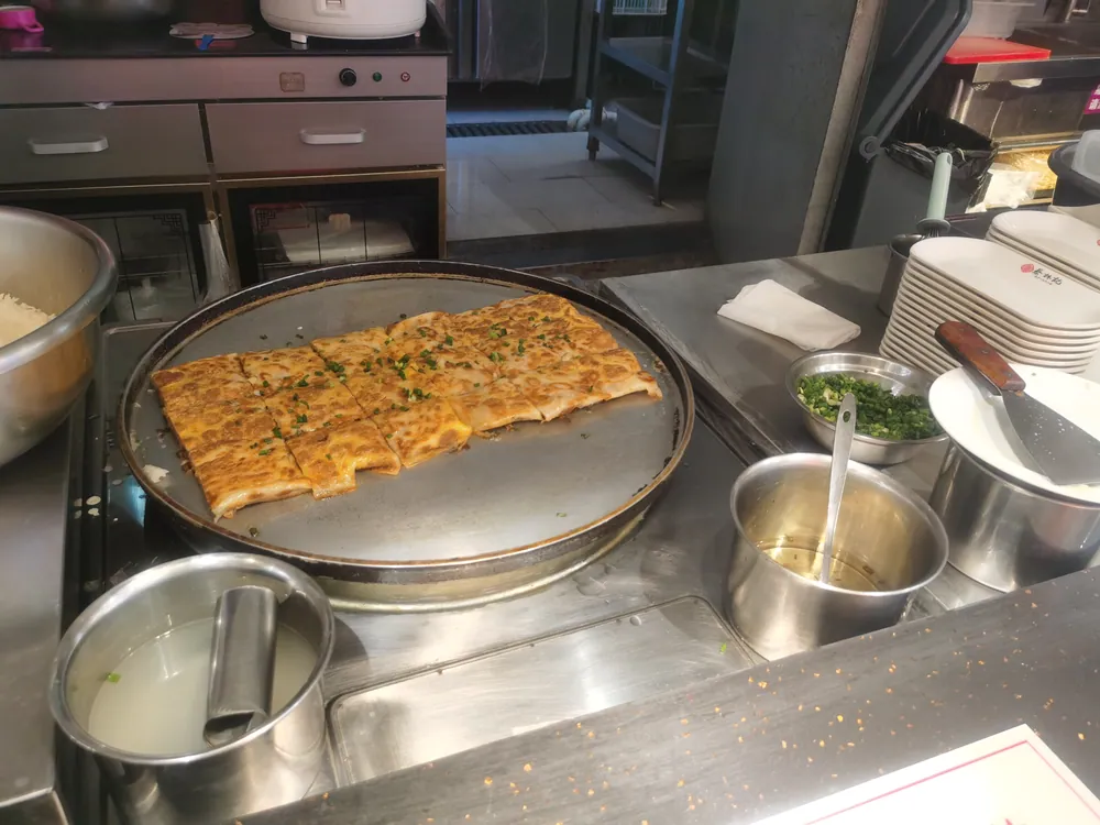 Doupi cooking on a flat pan in a Wuhan kitchen